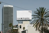 White billboard showing Los Angeles next to Verifi building with palm trees